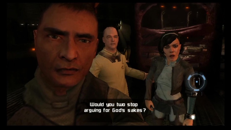 Two men and a woman look at the player. The woman says “Would you two stop arguing for God’s sakes?”.